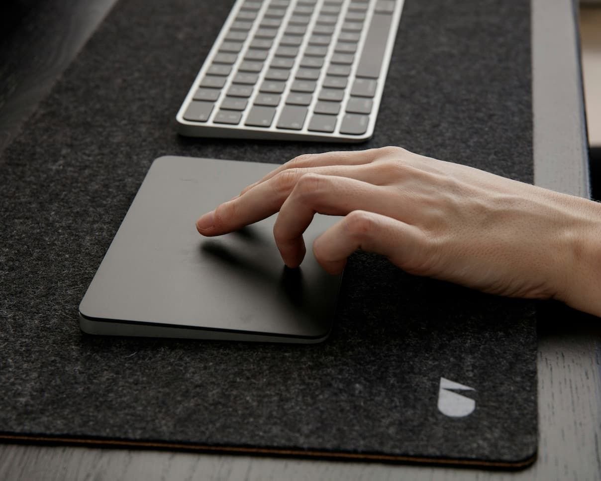hand-on-trackpad-next-to-keyboard.jpg